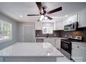 Modern kitchen with stainless steel appliances, white cabinets, and marble countertops at 600 Burns St, Wadesboro, NC 28170