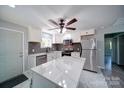 Modern kitchen with stainless steel appliances, white cabinets, and marble countertops at 600 Burns St, Wadesboro, NC 28170