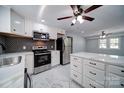 Modern kitchen with stainless steel appliances, white cabinets, and marble countertops at 600 Burns St, Wadesboro, NC 28170
