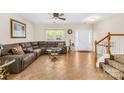 Spacious living room with tile floors, a comfortable sectional sofa, and staircase at 6418 Castlewynd Ct, Charlotte, NC 28212