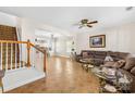 Open-concept living room with tiled flooring and staircase leading to kitchen area at 6418 Castlewynd Ct, Charlotte, NC 28212