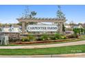 Inviting entrance to Carpenter Farms neighborhood with stone accents, landscaping, and clear signage at 715 Olde England Dr, Lincolnton, NC 28092
