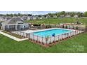 Community pool area with a slide, seating, landscaping, and a clubhouse in a new home development at 715 Olde England Dr, Lincolnton, NC 28092