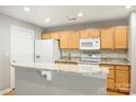 Bright kitchen featuring stainless steel appliances, light wood cabinets, and breakfast bar at 718 W Trade St # 708, Charlotte, NC 28202
