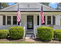 Welcoming entrance with American flags and manicured bushes at 8044 Eagle St, Mount Pleasant, NC 28124