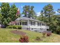 Beautiful home with green lawn, flag, and flowers at 8044 Eagle St, Mount Pleasant, NC 28124