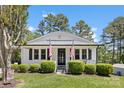 Inviting home exterior featuring American flags, well-maintained landscaping, and a welcoming entrance at 8044 Eagle St, Mount Pleasant, NC 28124