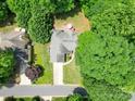 Aerial view of a charming home surrounded by lush greenery and mature trees at 8623 Cedar Hollow Ln, Huntersville, NC 28078