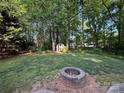 Large backyard with mature trees, a storage shed, a fire pit and plenty of green space at 8623 Cedar Hollow Ln, Huntersville, NC 28078