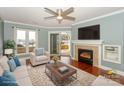 Cozy living room featuring a fireplace, lake views, and sliding glass door access at 867 Southwest Dr, Davidson, NC 28036