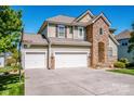 Charming two-story home with a well-maintained lawn and three-car garage, blending stone and siding details at 9860 Darby Creek Nw Ave, Concord, NC 28027