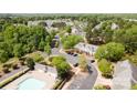 Scenic aerial view of the community pool, parking, and lush green surroundings at 1032 Eagles Nest Ln, Indian Land, SC 29707