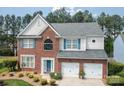 Charming two-story house featuring brick, light gray siding and a 2-car garage at 11312 Fox Hill Dr, Charlotte, NC 28269