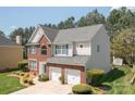 Well-maintained two-story home with brick accents, neutral siding and a two-car garage at 11312 Fox Hill Dr, Charlotte, NC 28269