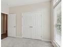 A spacious bedroom features ample closet space, and is filled with natural light at 117 Pine Lake Dr, Monroe, NC 28110