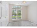 Bright bedroom with large windows offering natural light, complemented by neutral walls and plush carpet at 117 Pine Lake Dr, Monroe, NC 28110