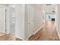 Inviting hallway featuring wood floors that seamlessly connect to a living room with a fireplace at 117 Pine Lake Dr, Monroe, NC 28110