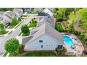 Aerial view of gray house with a backyard pool, patio, lush lawn, and landscaping at 1215 39Th Ne Ave, Hickory, NC 28601