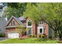 Charming brick home with lush green lawn, mature trees, and meticulously maintained landscaping at 1305 Foxfield Rd # 60, Waxhaw, NC 28173