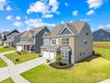 Beautiful two-story home with well-kept lawn, two-car garage, and inviting curb appeal in a suburban neighborhood at 13547 Roderick Dr, Huntersville, NC 28078