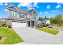 Attractive two-story home with a two-car garage, long driveway, and landscaped front yard at 13547 Roderick Dr, Huntersville, NC 28078