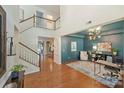 Elegant foyer with hardwood floors, an open staircase, and views into the living spaces at 1405 Ridge Haven Rd, Waxhaw, NC 28173