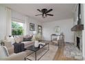 Inviting living room with ample natural light, a ceiling fan, fireplace and neutral color palette at 2138 Revolution Park Dr, Charlotte, NC 28208