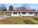 Charming single-story home featuring a well-maintained lawn, carport, and freshly painted white brick exterior at 2232 Glenraven Ave, Gastonia, NC 28052