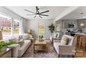 Bright living room with modern ceiling fan, neutral decor, and open layout to the kitchen at 2232 Glenraven Ave, Gastonia, NC 28052