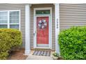 Inviting front door with decorative wreath and well-maintained landscaping at 2388 Loch Stone Dr # E, Gastonia, NC 28054