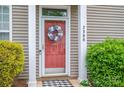 Inviting front door with decorative wreath and well-maintained landscaping at 2388 Loch Stone Dr # E, Gastonia, NC 28054
