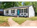 View of a charming home featuring a newly painted exterior, black shutters, and a vibrant turquoise front door at 2515 Danforth Ln, Charlotte, NC 28208