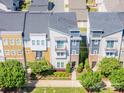 Aerial view of colorful townhomes in a well-maintained community surrounded by lush trees at 2551 Statesville Ave, Charlotte, NC 28206