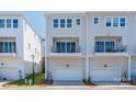 Modern townhome featuring attached garages, clean lines, and neutral siding at 2551 Statesville Ave, Charlotte, NC 28206