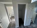 Hallway showing access to a half bath and a storage closet with modern flooring at 2815 Cartesian Dr, Charlotte, NC 28214