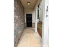 Covered entryway featuring stone accents and a dark-colored front door at 3019 Glenn Hope Way, Matthews, NC 28104