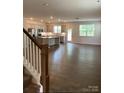Open-concept living room and kitchen with hardwood floors and natural lighting at 3019 Glenn Hope Way, Matthews, NC 28104