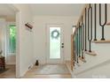 Bright foyer featuring hardwood floors, white walls and a decorative staircase at 3232 Johnny Cake Ln, Charlotte, NC 28226