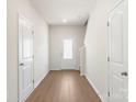 Bright entryway with wood-look floors, white trim, and a glass panel front door at 3340 Burberry Dr, Gastonia, NC 28052