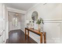 Bright entryway features dark wood floors, a console table, and an elegant mirror at 4237 Island Fox Ln, Denver, NC 28037