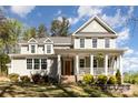 Charming two-story home with a large front porch and landscaped yard at 4237 Island Fox Ln, Denver, NC 28037