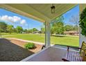 Covered front porch with tiled flooring and a peaceful view of the landscaped yard at 4307 Wrangler Sw Dr, Concord, NC 28027