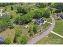 Expansive aerial view of a well-maintained home with lush landscaping, a firepit, and a serene neighborhood at 520 Steeple Chase Trl, Salisbury, NC 28144