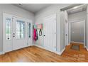 Bright foyer with hardwood floors, a decorative glass door, and a coat rack at 520 Steeple Chase Trl, Salisbury, NC 28144