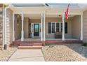 Inviting front porch with classic columns, brick steps, and a cozy bench at 520 Steeple Chase Trl, Salisbury, NC 28144