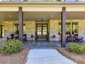 Inviting front porch with stone accents and comfortable seating area at 5933 Legacy Ln, Kannapolis, NC 28081