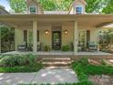 Inviting front porch featuring comfortable seating, decorative plants, and a welcoming entrance at 5935 Winburn Ln, Charlotte, NC 28226