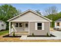 Charming home features a quaint covered porch and fresh landscaping at 606 & 608 Hampton Rd, Lancaster, SC 29720