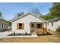 Quaint home features charming porch with wooden shutters and fresh landscaping at 606 & 608 Hampton Rd, Lancaster, SC 29720