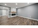 Spacious living room with modern fireplace, floating shelves and beautiful floors at 606 & 608 Hampton Rd, Lancaster, SC 29720